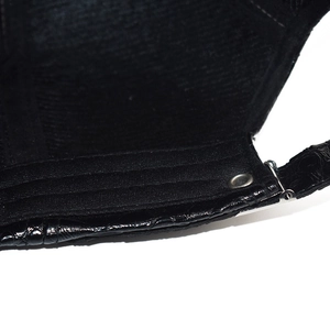 Detail of black faux crocodile skin baseball cap showing adjustable silver buckle and stitching