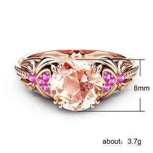 Rose gold ring with 8mm pink champagne gemstone and floral side stones on white background