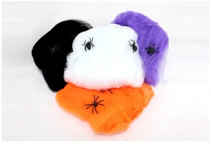 Close-up of colorful Halloween spider webs in black, white, purple, and orange with spiders