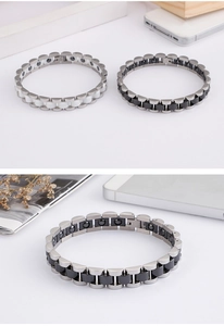 Macro detail of men's titanium steel and ceramic magnetic bracelet showing inlay work