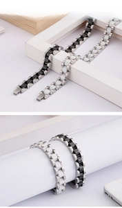 Detail view of titanium steel and ceramic men's bracelet with H-link design and secure clasp