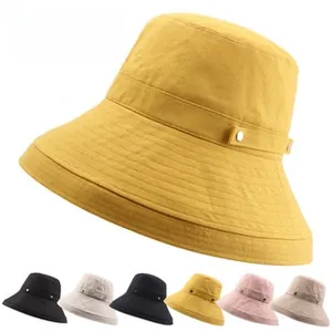 Detail of canvas sun hat with decorative band and metallic buckle in diverse color palette