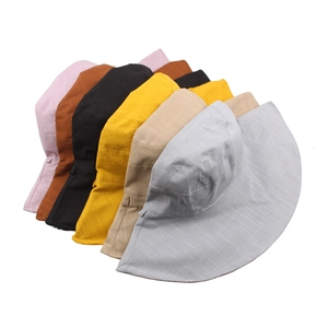 Multi-color wide brim cotton sun hats in pink, brown, black and beige on white background