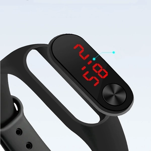 Macro side view of black LED digital sports watch showing time display and silicone strap