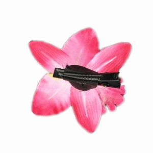 Detail view of the black metal duckbill clip attachment on a pink silk orchid hair flower