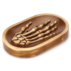 Macro side view of gothic skull hand soap dish with realistic bone details and drainage holes