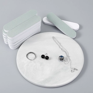 Dual-sided jewelry polishing sticks for cleaning silver rings and necklaces on a tray