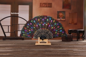 Detail of black folding fan featuring colorful sequin embroidery with peacock patterns