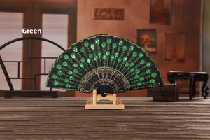 Detail of green sequin flower embroidery on a black lace folding fan with display stand