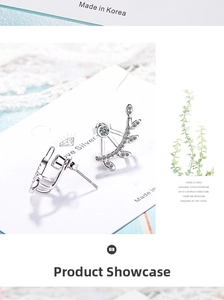 Detailed close-up of silver leaf earrings with sparkling cubic zirconia on a white card