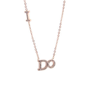 Close-up of rose gold necklace featuring sparkling I DO letter pendants with clear crystals