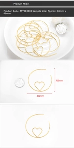 Detail view of 48mm gold heart hoop earrings with size reference and coin comparison