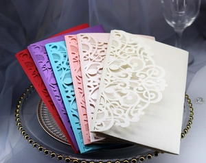 Detailed stack of laser-cut invitation envelopes in five elegant pearlescent paper colors