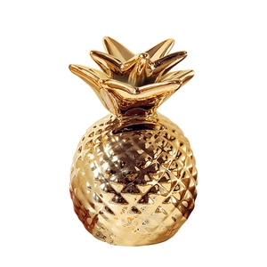Glossy gold pineapple ceramic storage jar with detailed leaves and reflective mirror finish