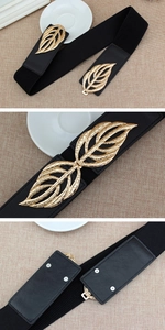 Detail of black elastic waist belt featuring golden leaf buckle and rivet structure