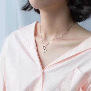 Minimalist silver moon and cat pendant necklace worn by female model for a sweet style
