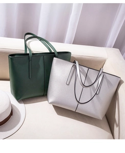 Detail of high-quality PU leather tote with vertical stitching and smooth metallic finish