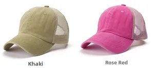 Detail view of khaki and rose pink trucker hats with mesh back and stitched brims