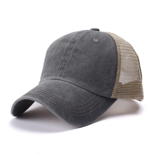 Detail of distressed grey washed cotton and breathable beige mesh on back of trucker hat
