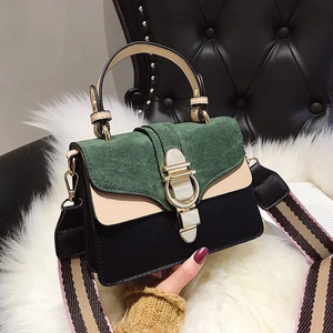 Green and beige patchwork crossbody bag with striped wide shoulder strap and gold buckle