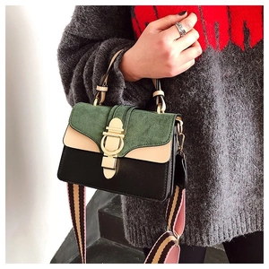 Detail of color-block flap bag featuring green suede, beige leather, and golden horseshoe clasp