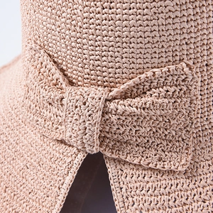 Straw sun hat for women featuring a large brim and stylish back bow tie detail