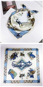Detail of silk square scarf featuring equestrian print with horses and ribbons pattern