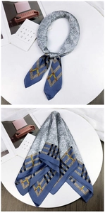 Detail of silk square scarf featuring geometric navy and marble texture patterns