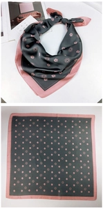 Detail of silk-texture square scarf featuring pink camellia pattern and contrast stitching