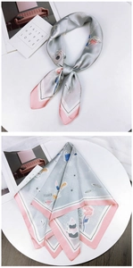 Detail of silver silk scarf with pink borders featuring modern lipstick and rose prints