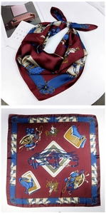 Detail of silk square scarf featuring classic equestrian horse print in burgundy and blue