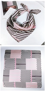Detail of pink and black geometric striped silk scarf shown tied and laid flat