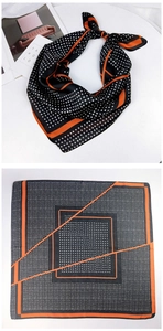 Polka dot silk scarf with black background and orange geometric lines in detail
