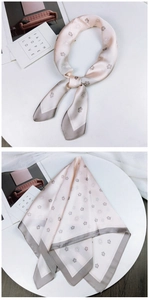 Detail of silk scarf featuring champagne pink camellia patterns and contrast grey edges