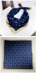 Detail of camellia print silk scarf in navy and cream with smooth satin texture