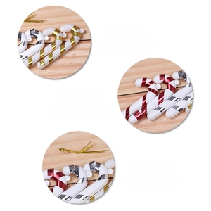 Detail of red gold and silver plastic candy cane ornaments with gold hanging ropes