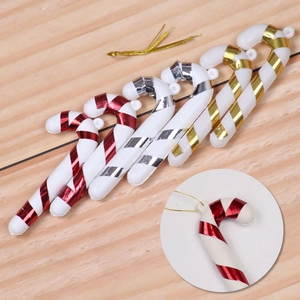 Detail of 6-pack plastic Christmas candy canes with metallic ribbons on wood background