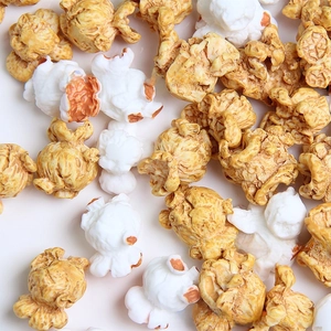Detailed close-up showing realistic texture of resin popcorn charms in white and yellow