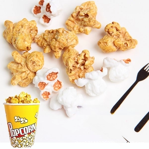 Macro shot of realistic resin popcorn charms in white and caramel colors for DIY jewelry