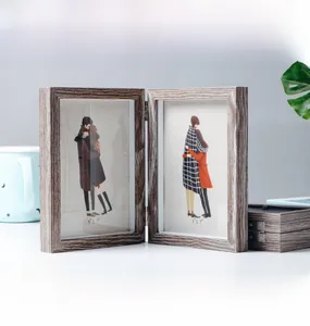 Close-up of a 5x7 wood grain folding double frame with metal hinges and artistic illustrations