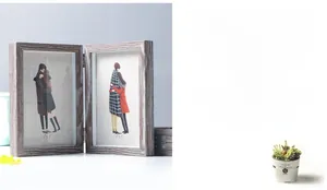 Detail of a foldable wooden double picture frame with 5x7 inch inserts and metal hinges
