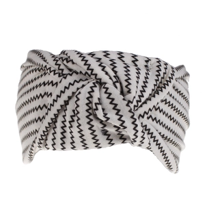 Detail of bohemian knitted headband with black and white zigzag pattern and twisted knot design