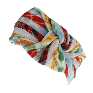 Detail view of the bohemian wide twisted headband featuring vibrant colorful geometric patterns