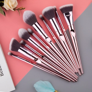 12-piece rose gold makeup brush set with synthetic bristles on pink and grey background
