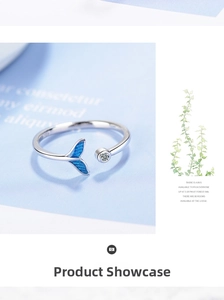 Detailed close-up of a blue enamel fishtail ring with a small sparkling zircon stone