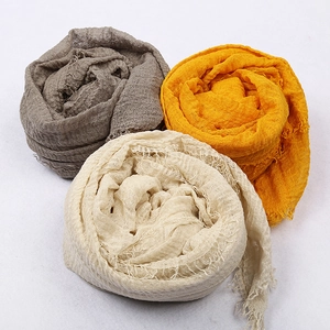 Textured voile scarves in taupe, yellow and cream with fringed edges on white background