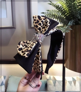 Detail of leopard print double layer bow headband with sparkling rhinestone center