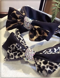 Detail of leopard print bow headbands featuring sparkling rhinestone center accents