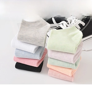 Detail of candy-colored low-cut cotton socks showing fine knit texture and ribbed cuffs