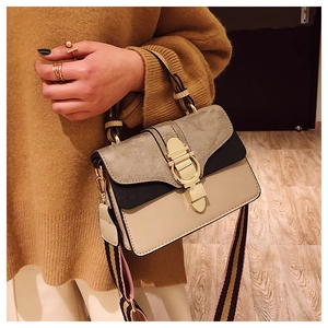 Detail of color-block crossbody bag with suede finish and wide fabric shoulder strap